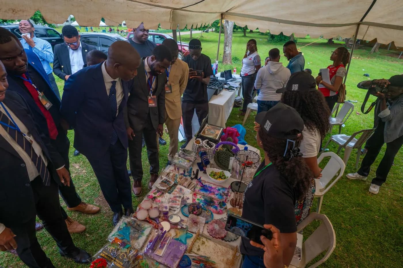 Delegates browsing products on display under the fair tent