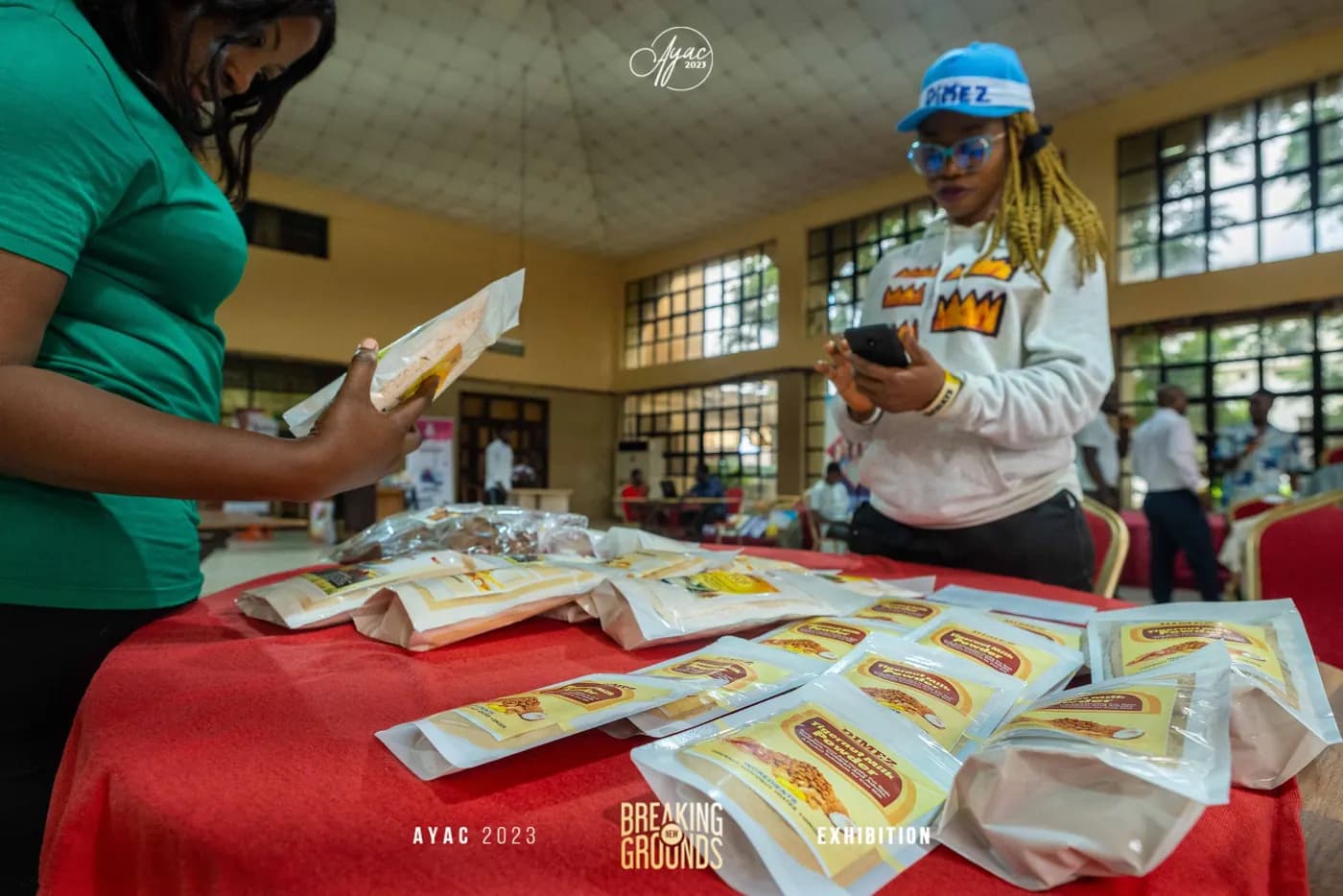 An exhibitor arranging packaged food products on her stand