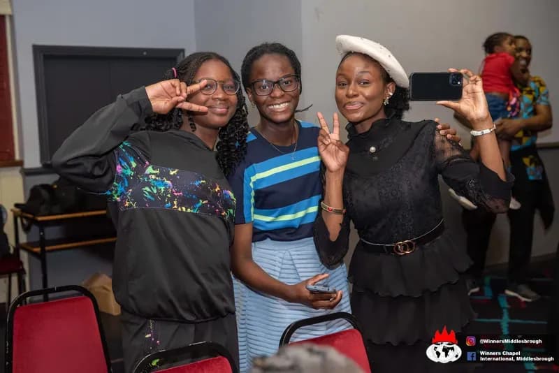 Three friends posing together after the service