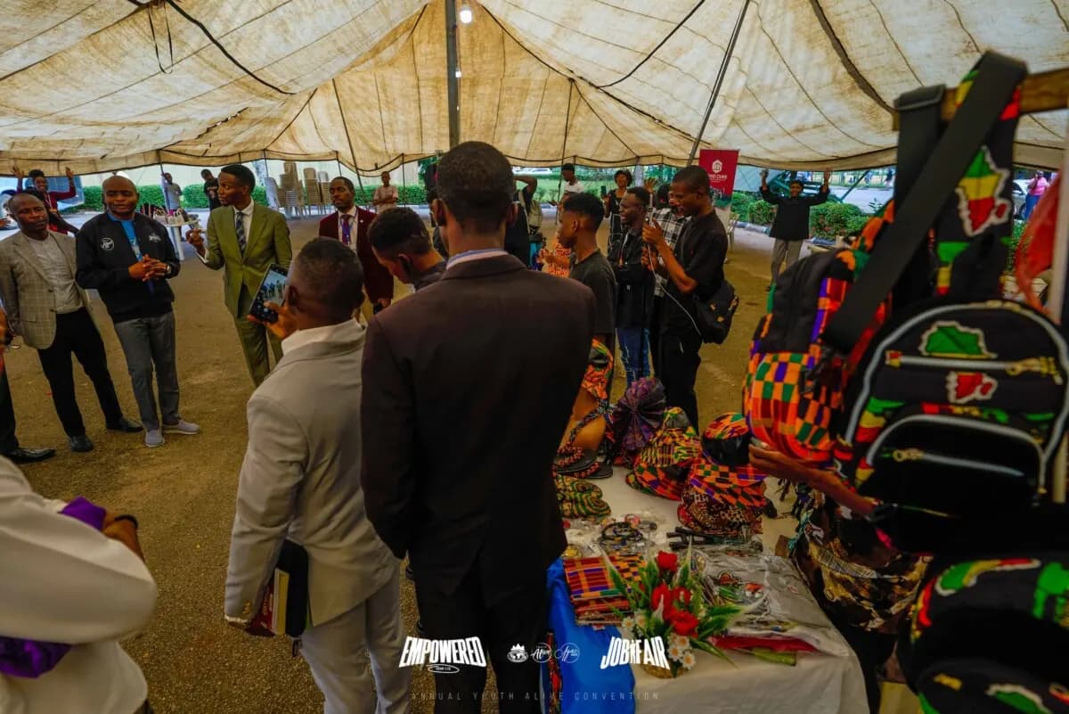 Delegates browsing African craft stands under the job fair tent
