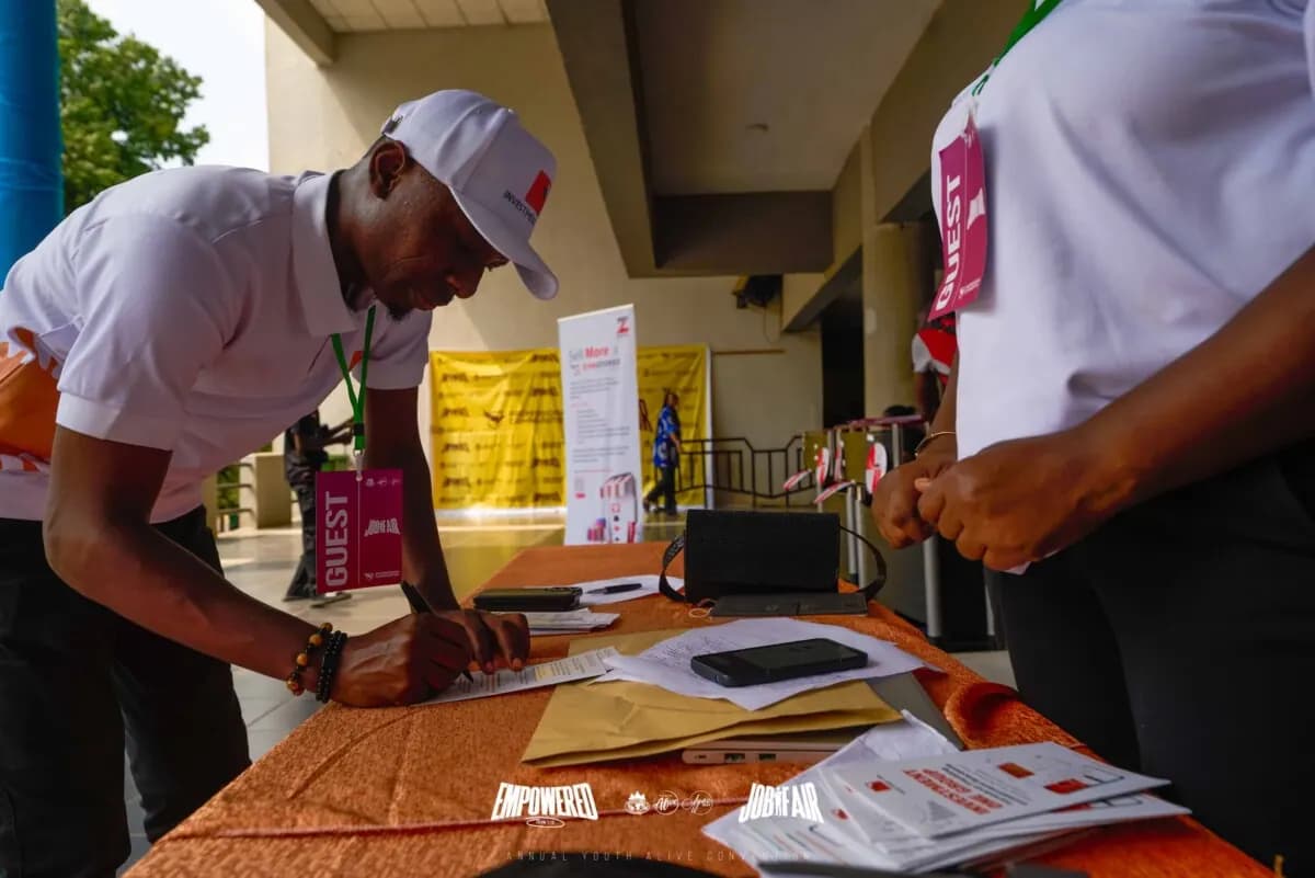 A guest signing in at the job fair desk