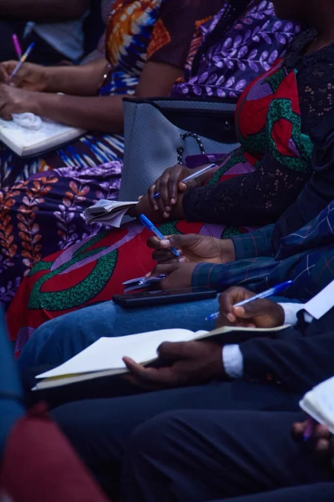 Students taking careful notes during a session