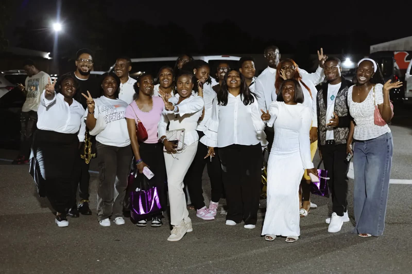 A group of delegates celebrating outside the venue at night